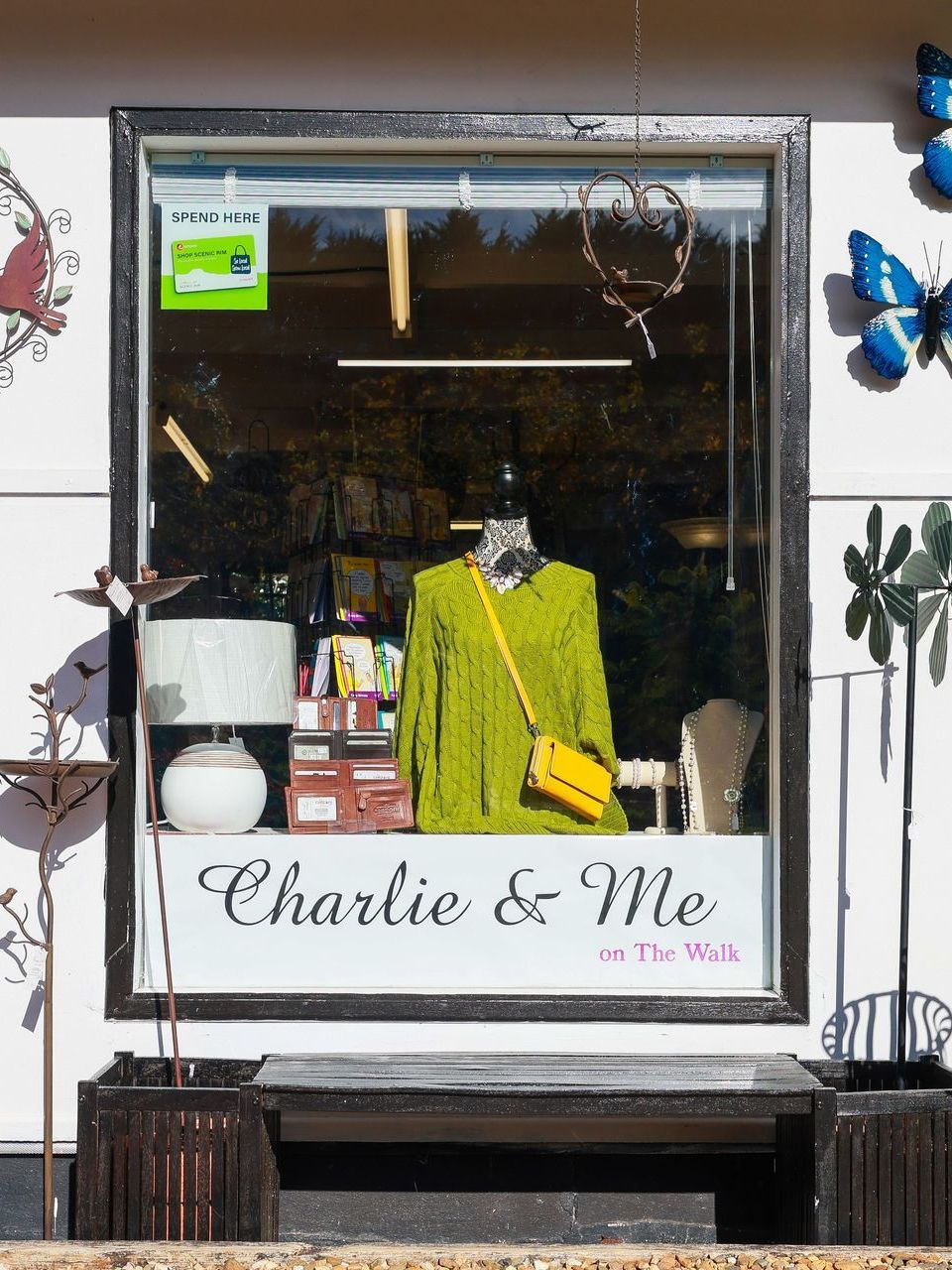 A store front with a window that says charlie & me