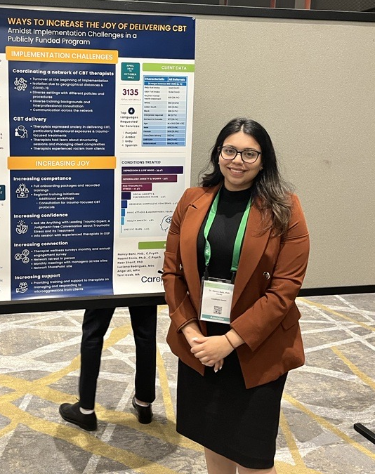 a woman stands in front of a poster titled ways to increase the joy of delivering cbt