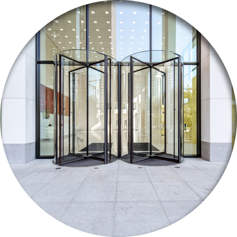 A clean office entrance with revolving doors