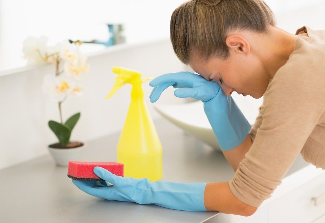 A frustrated employee cleaning office bathroom