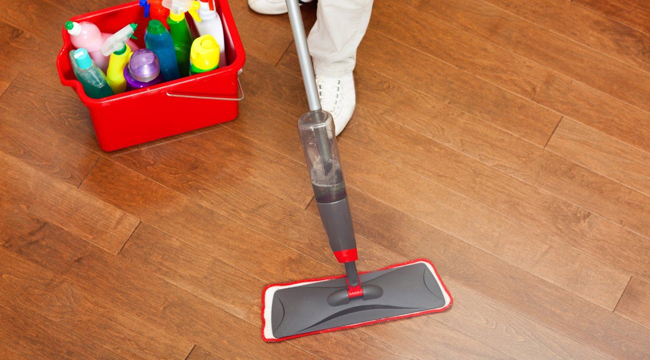 A professional cleaner mopping an office floor