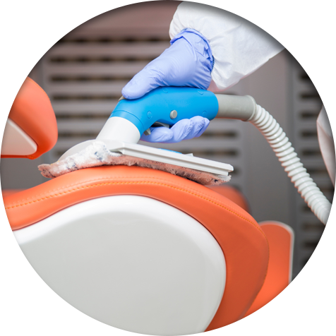 Commercial cleaner using  specialized equipment to clean a dental chair