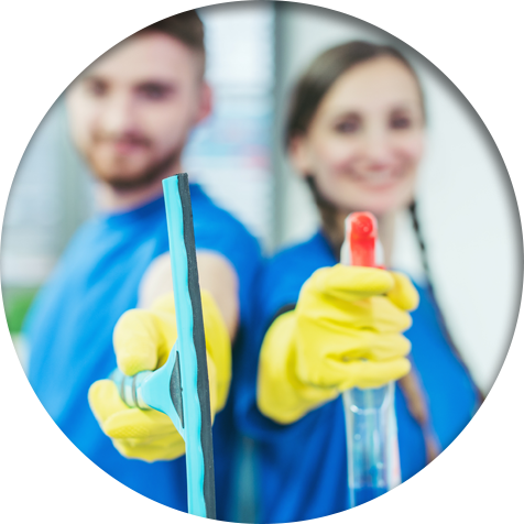 Commercial cleaners wearing yellow gloves while holding a spray bottle and glass cleaner