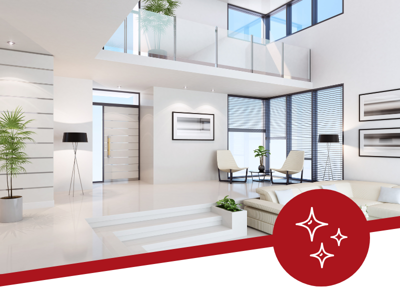 A living room with a lot of windows and a red circle with stars on it.