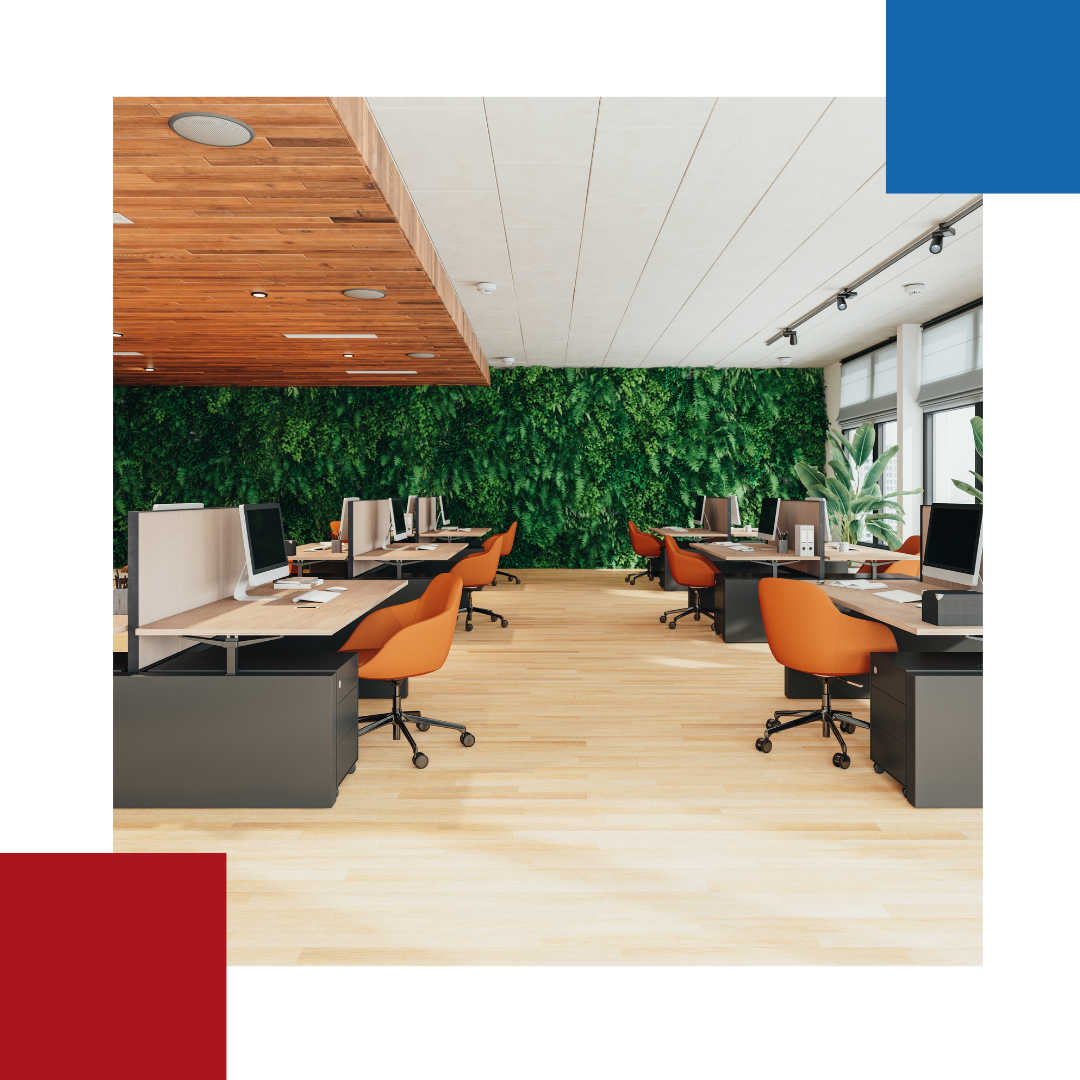 An office with a green wall behind the desks and chairs.