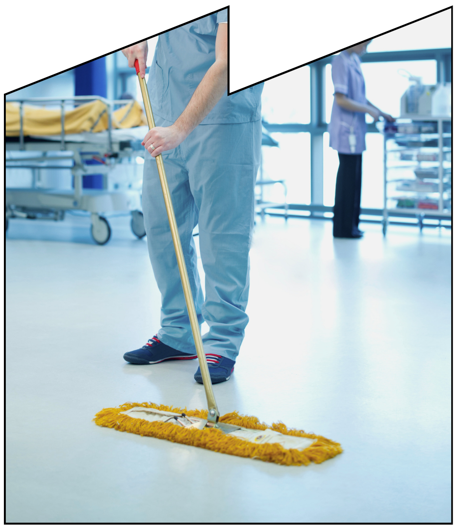 A man is mopping a hospital floor with a mop