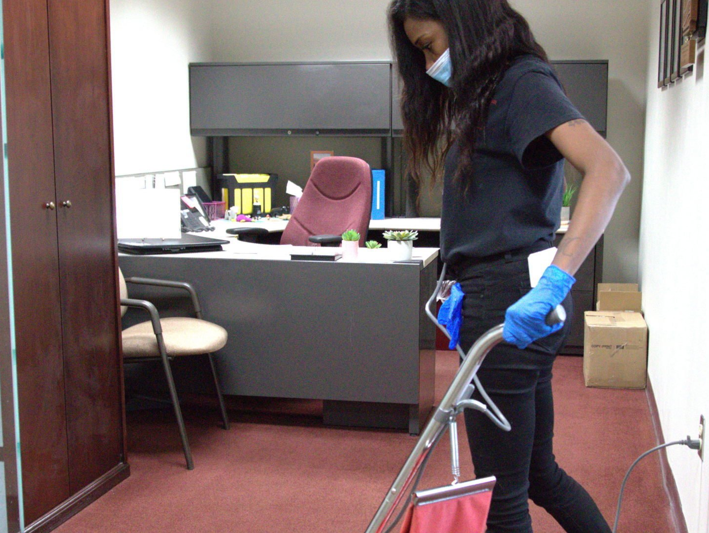 a woman with black shirt cleaning up a room