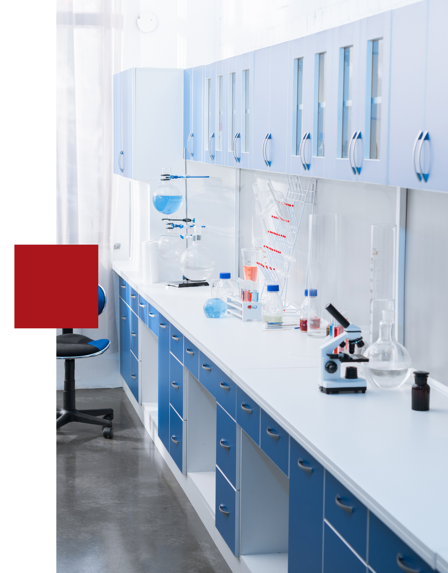 A laboratory with blue cabinets and white counter tops