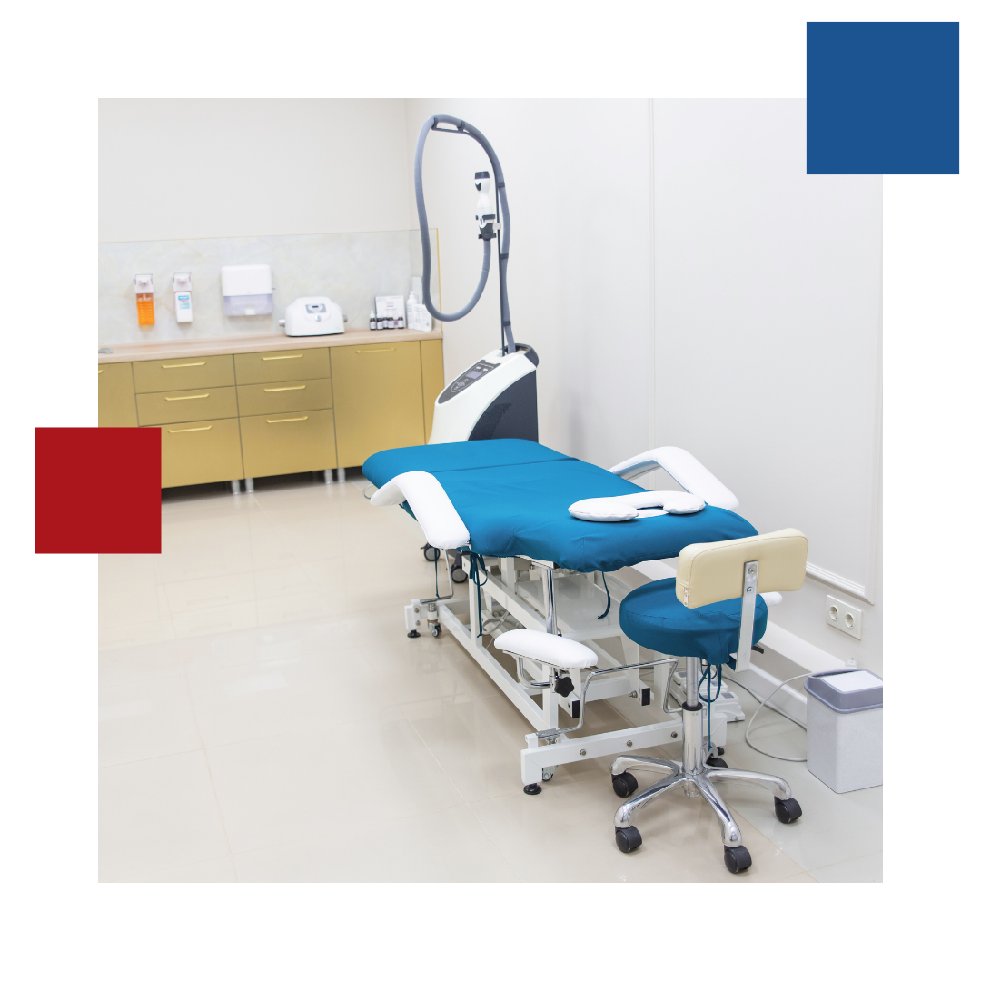 A surgery room with a blue table and a chair