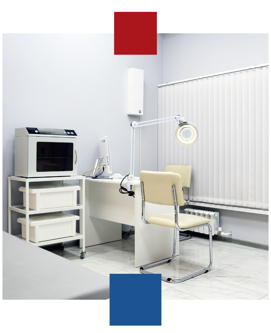 A doctor 's office with a desk and chair.