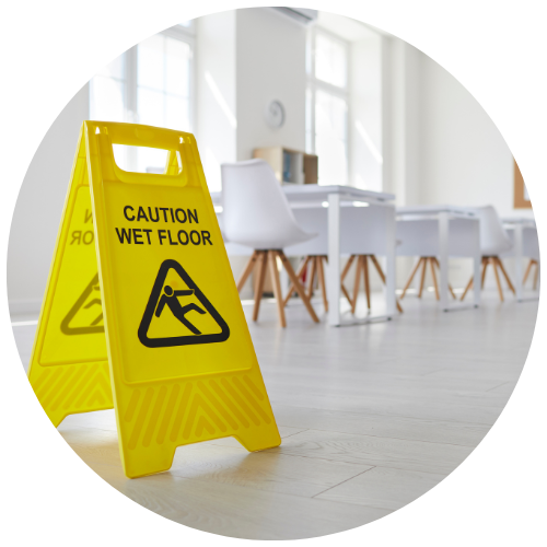 yellow sign that reads Caution Wet Floor standing in clean empty school classroom