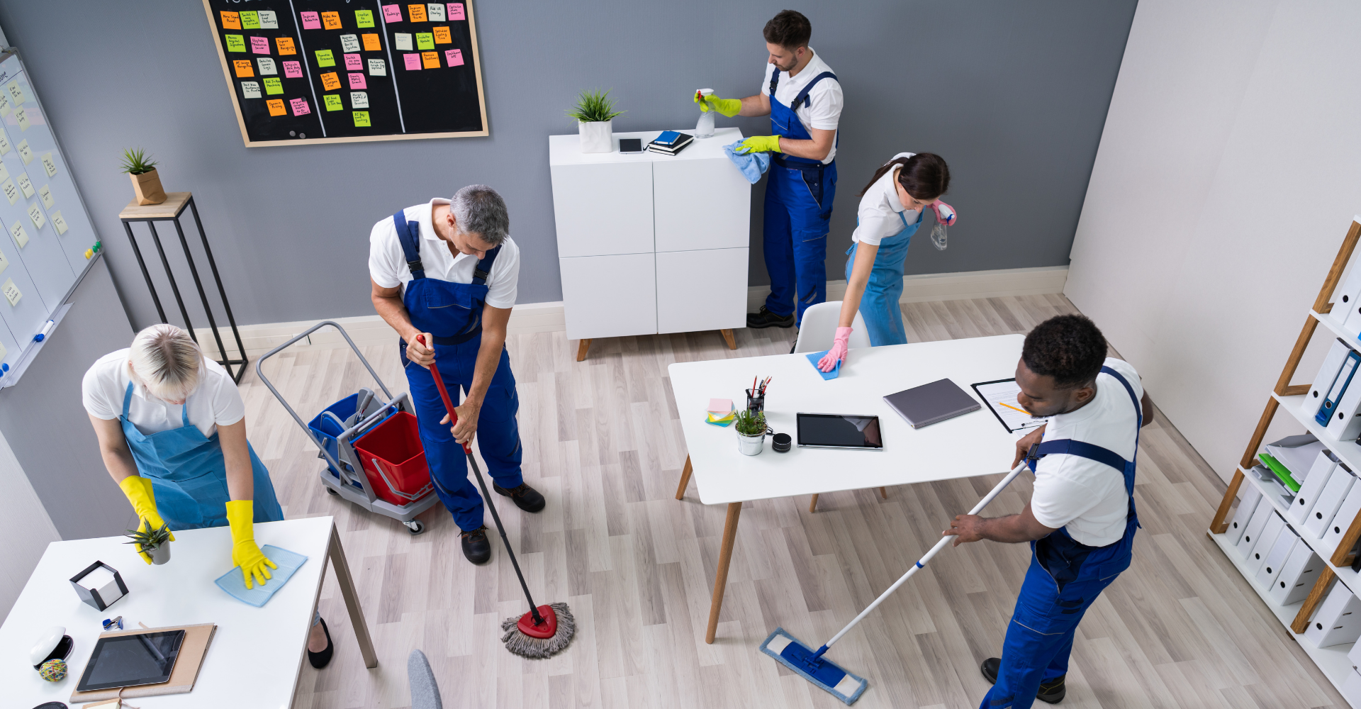 janitorial services team of five cleaning up an office