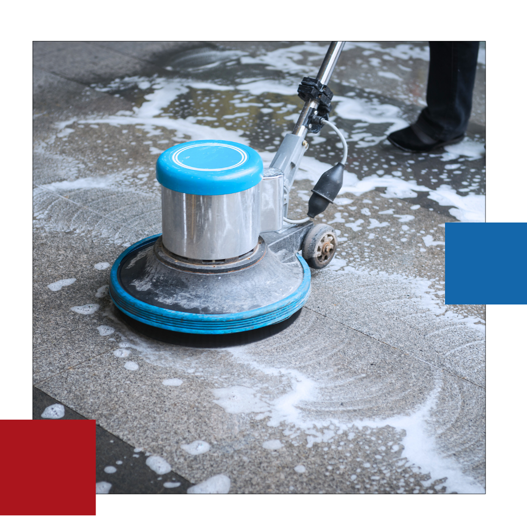 A person is cleaning a tile floor with a machine.