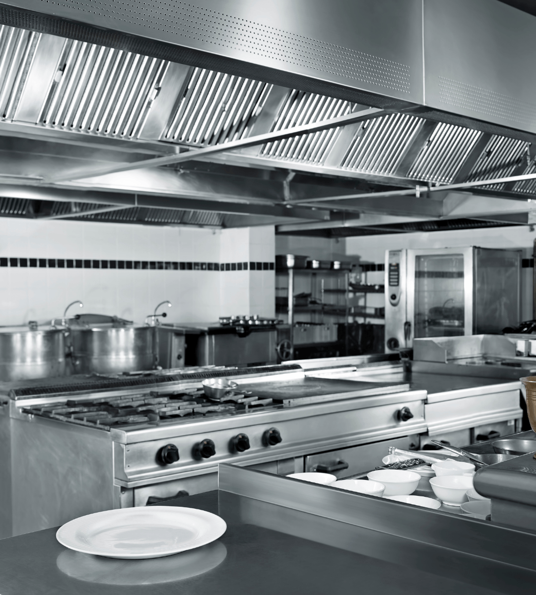Empty restaurant kitchen with pristine stainless steel appliances