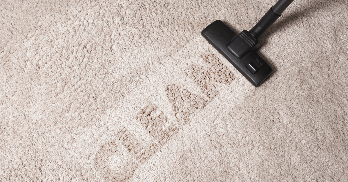 cleaning a carpet with vacuum cleaner with a clean text on a carpet