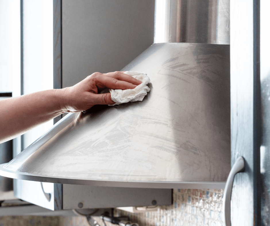 Cleaning stainless steel stove hood with white rag