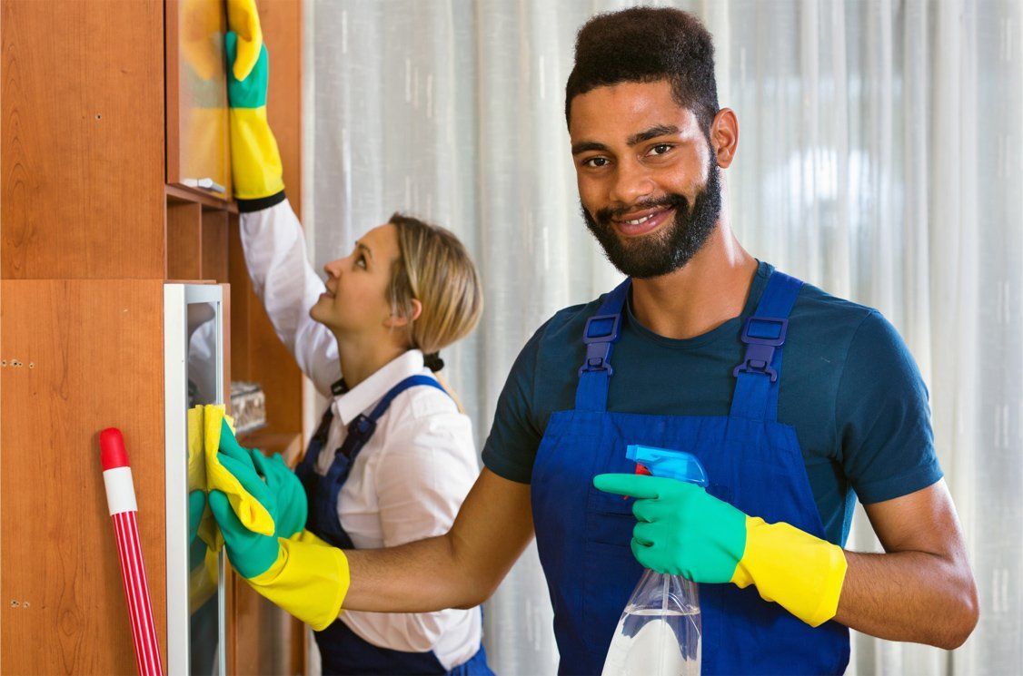 professional cleaners wearing gloves cleaning office