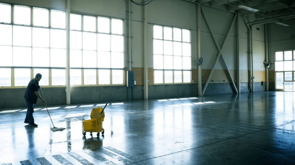 man mopping a warehouse floor