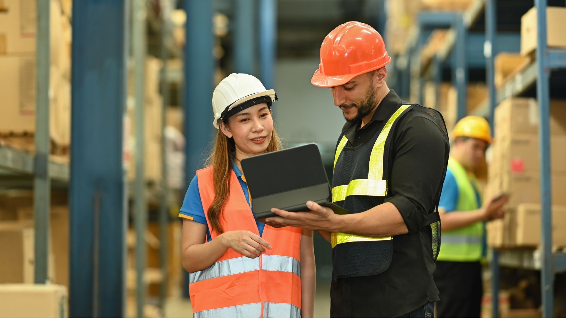woman and man warehouse workers going over inventory