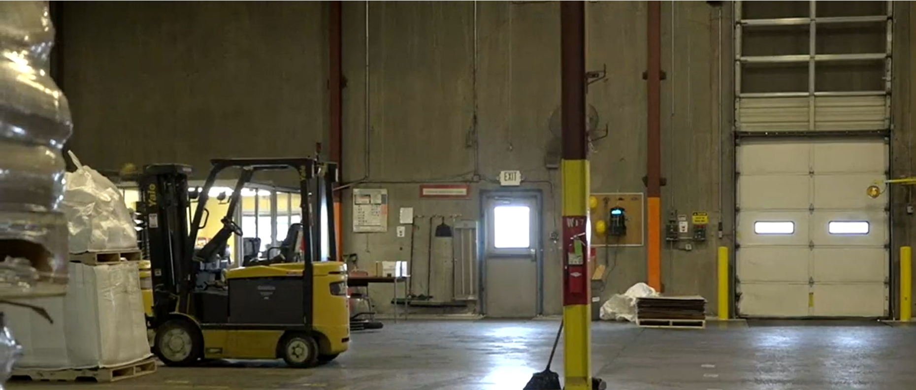 A forklift parked inside of the warehouse.