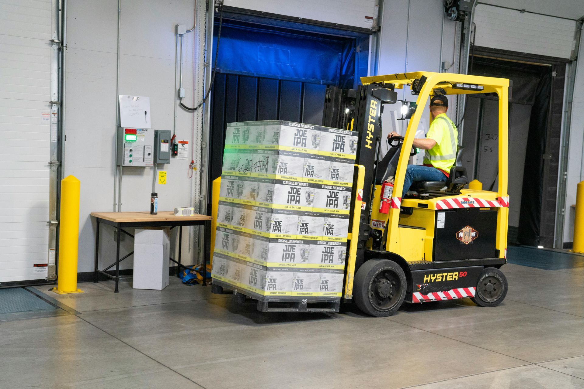 man driving a forklift in a warehouse
