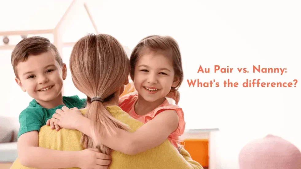 A woman is hugging two children in a room.