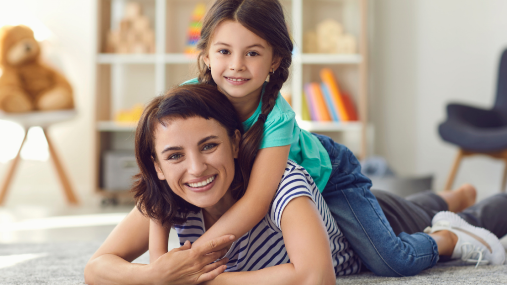A nanny and the girl shared a joyful smile