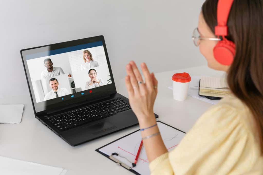 A woman sat intently and look at her laptop
