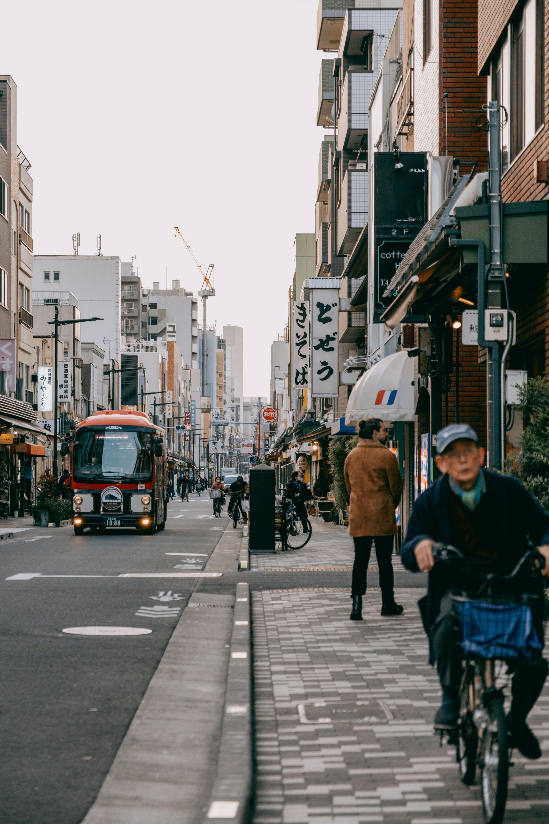 A man is riding a bike down a city street.