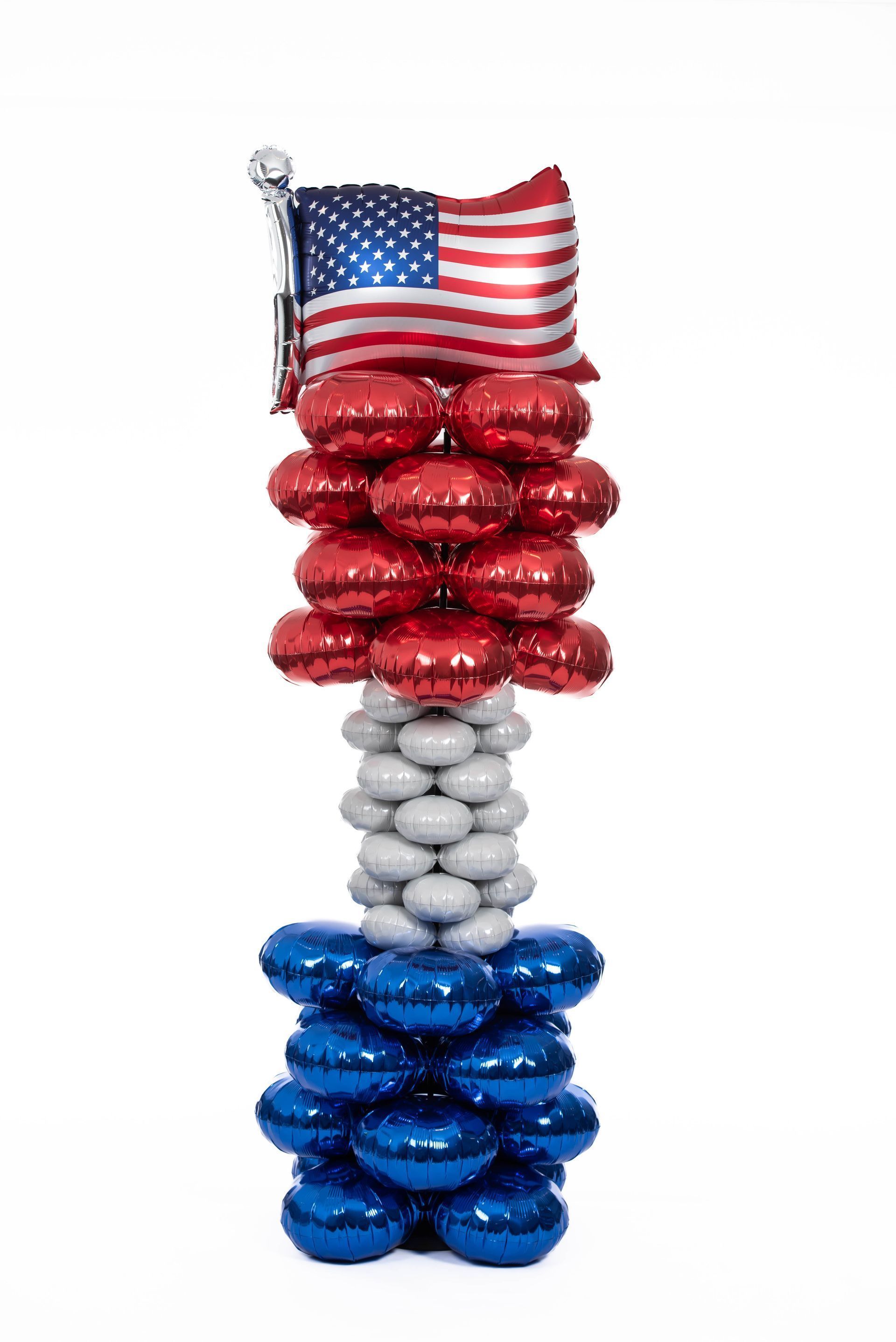 Balloon sculpture: US flag on a red, white, and blue column.