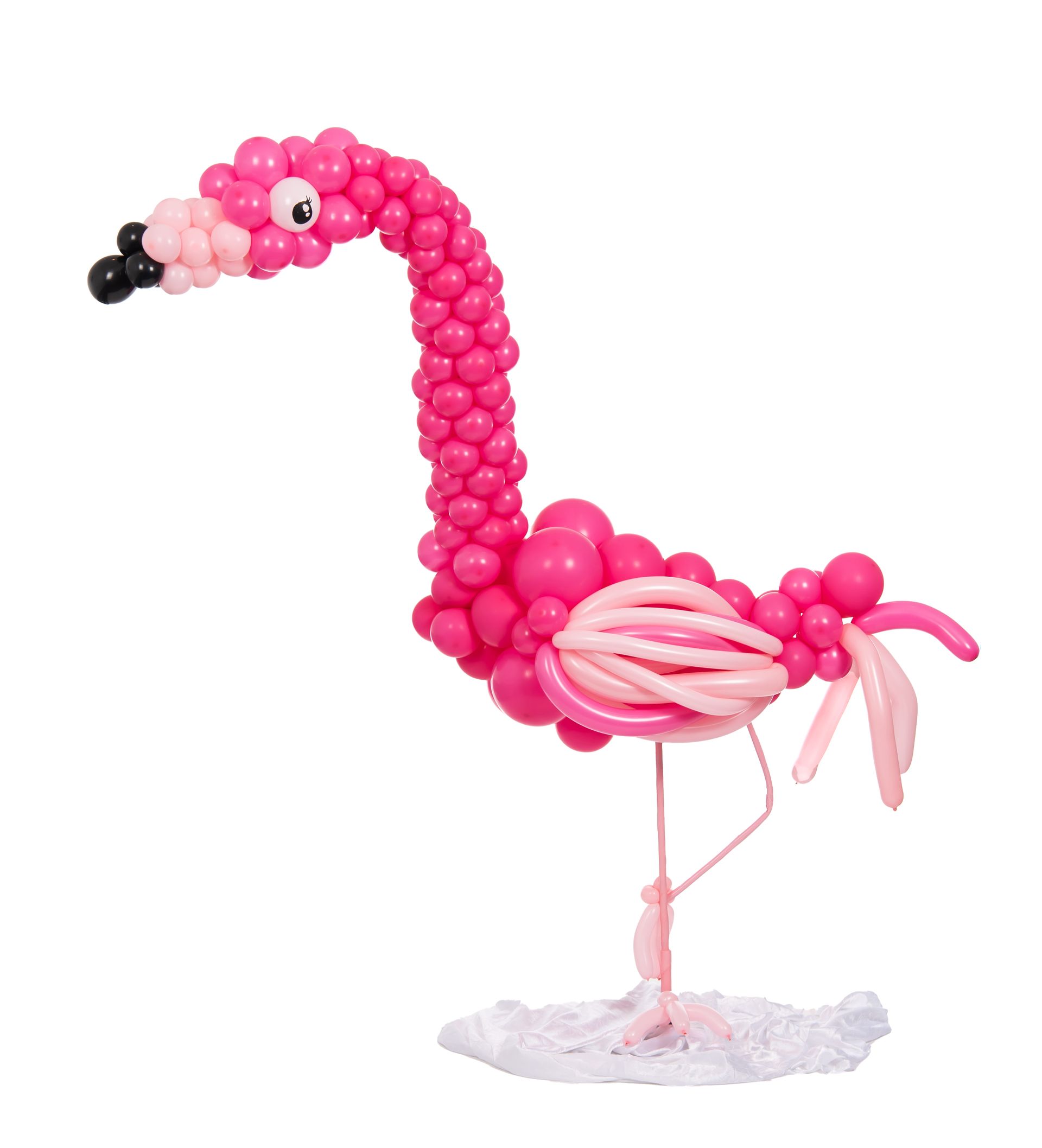 Pink balloon flamingo sculpture standing on one leg, with a black and pink beak.