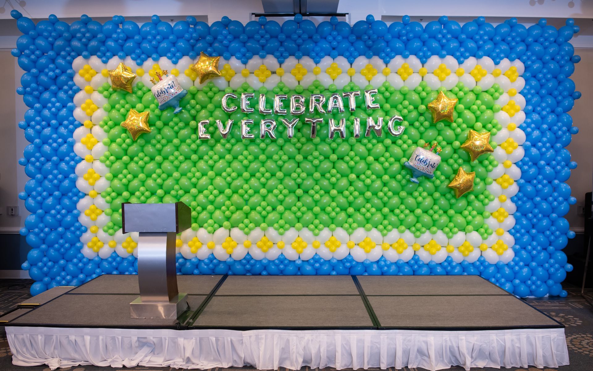 Stage with balloon backdrop reading