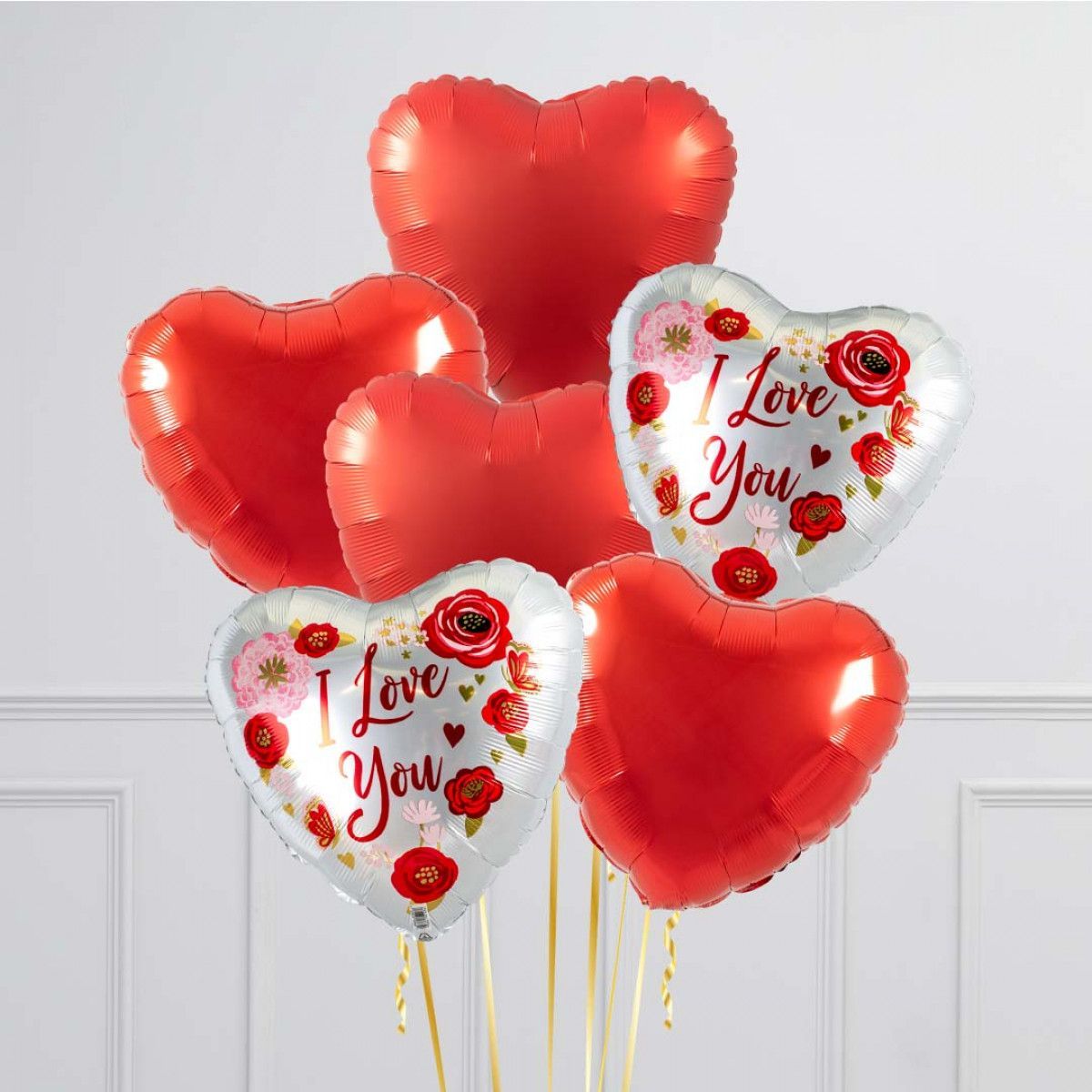 Christmas balloon decorations: elf, ornaments, and candy canes in red, green, white, and gold.