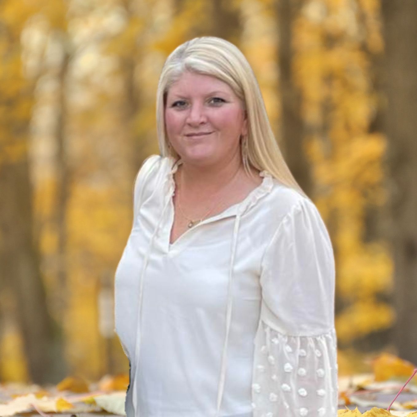 A man is carrying a woman on his back and kissing her on the cheek.
