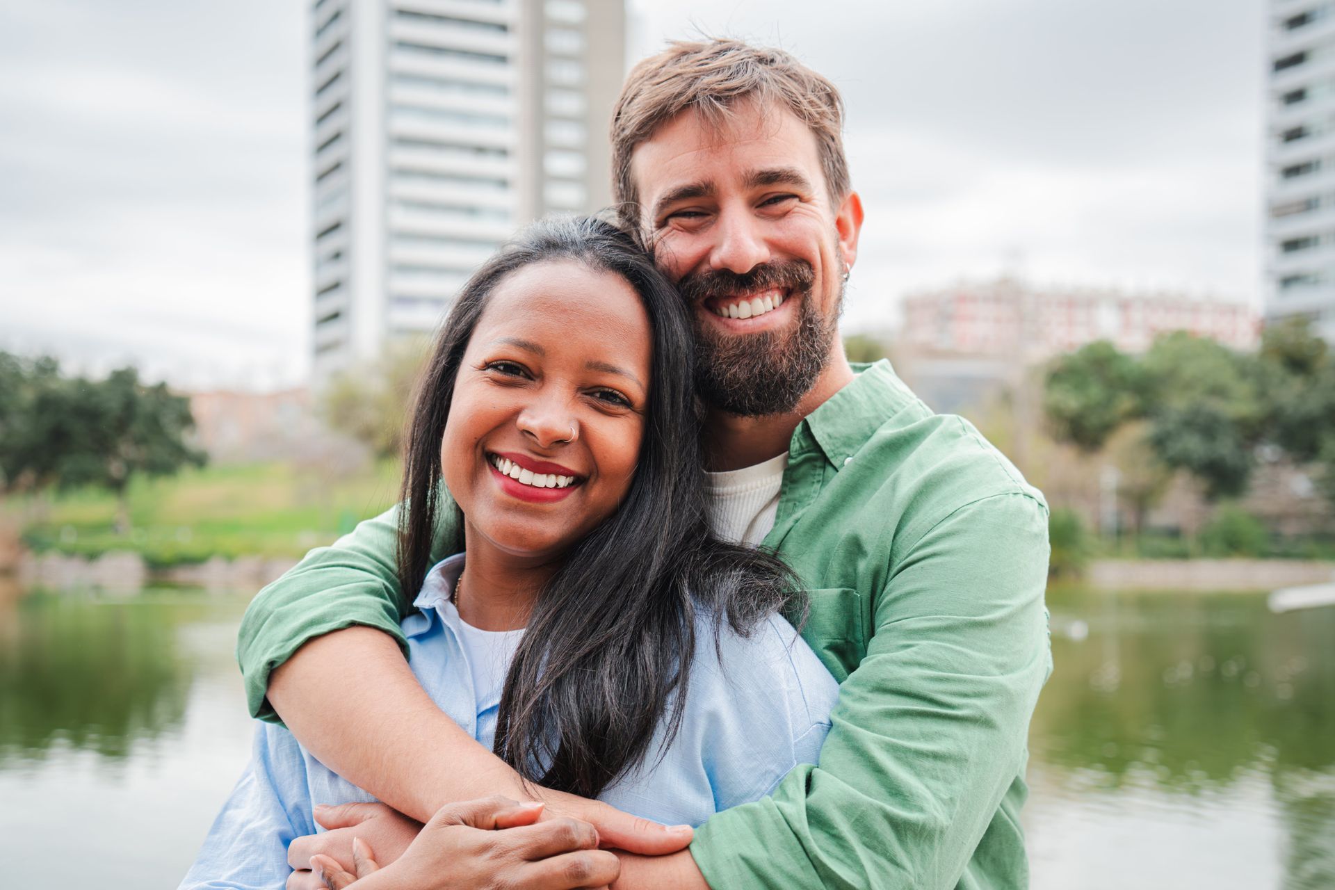A woman is covering her face with her hands.