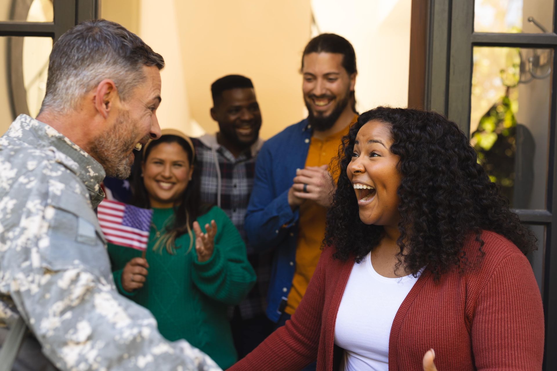 A woman is writing on a clipboard while a man wearing a mask looks on.