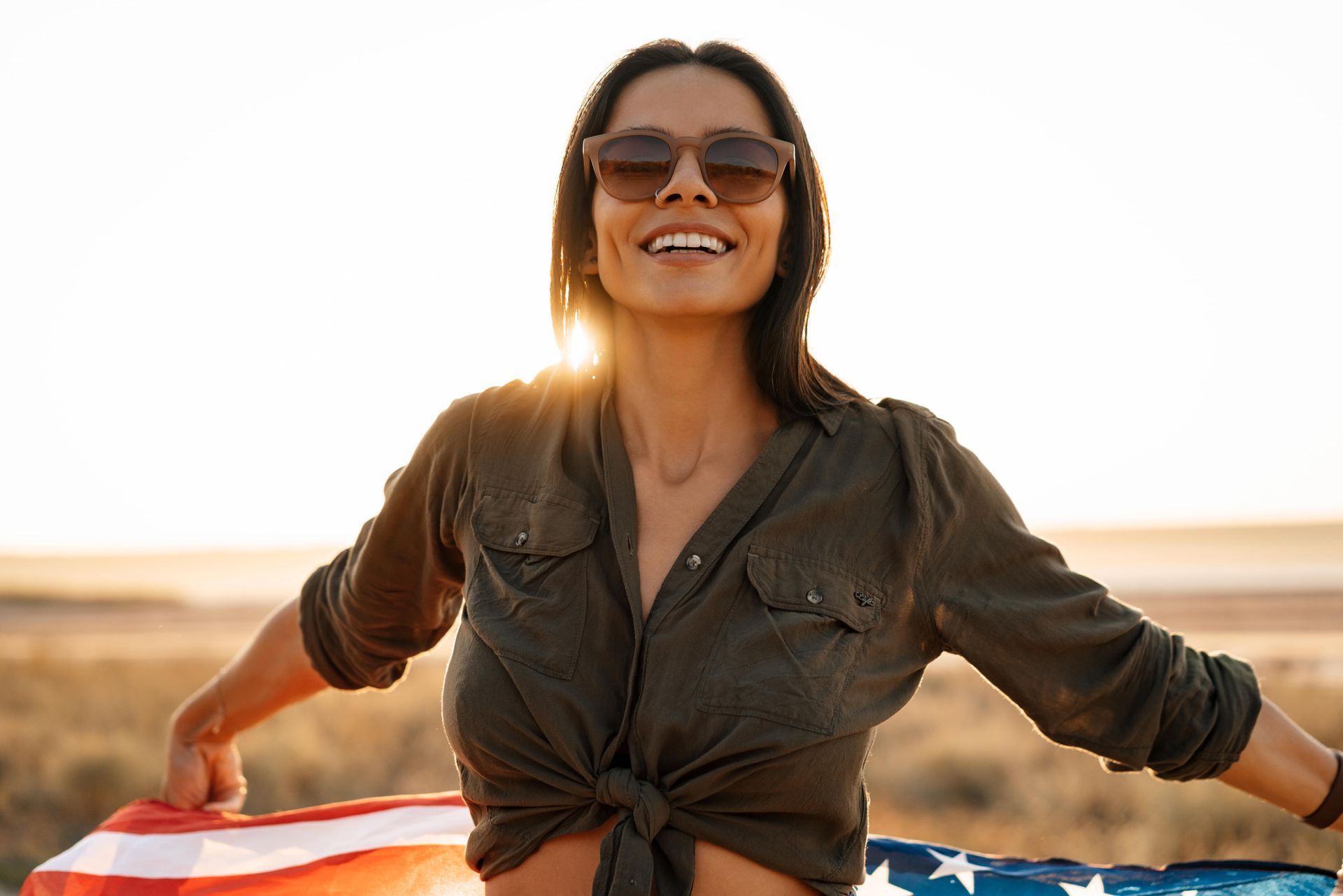A woman is covering her face with her hands.