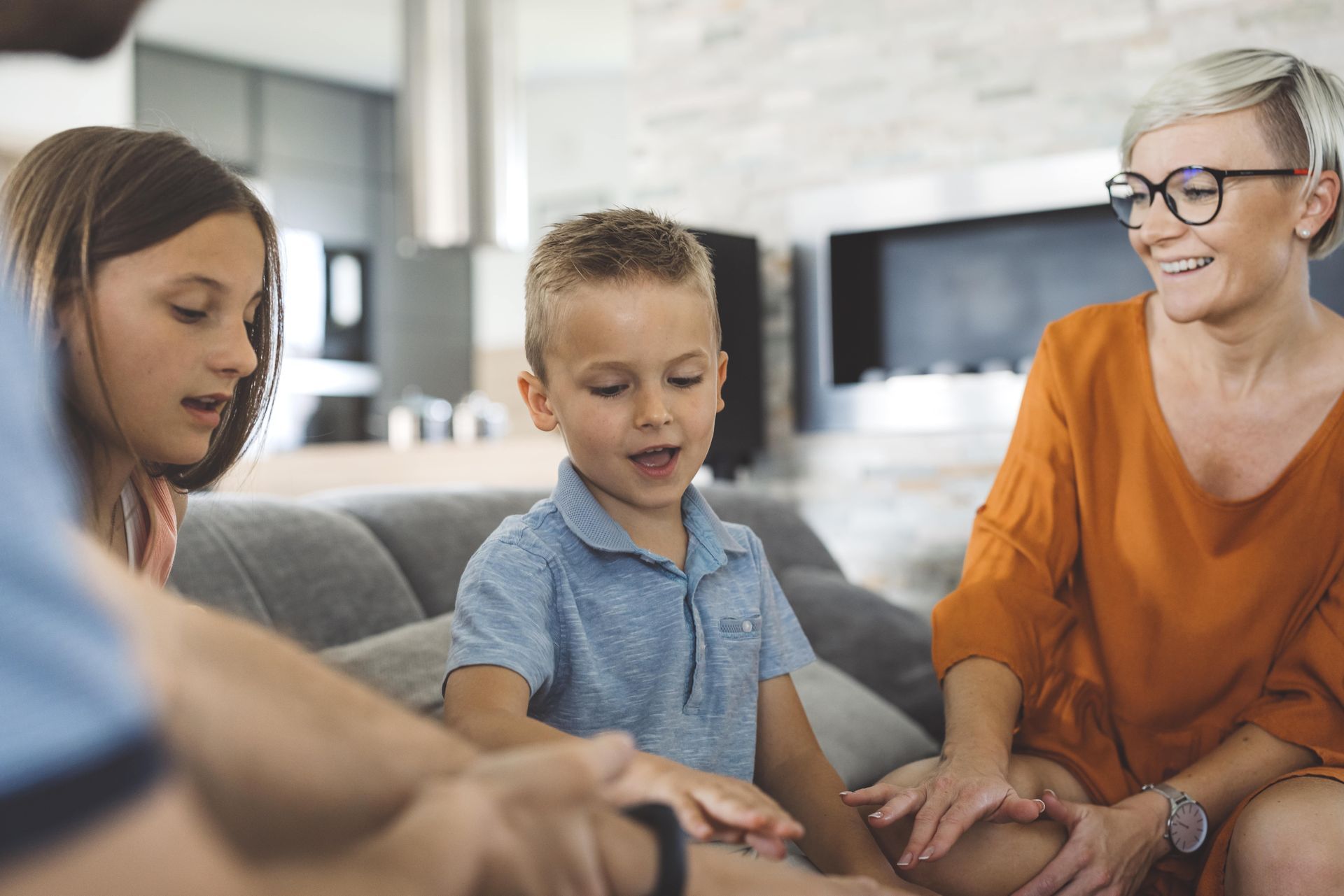 A woman is writing on a clipboard while a man wearing a mask looks on.