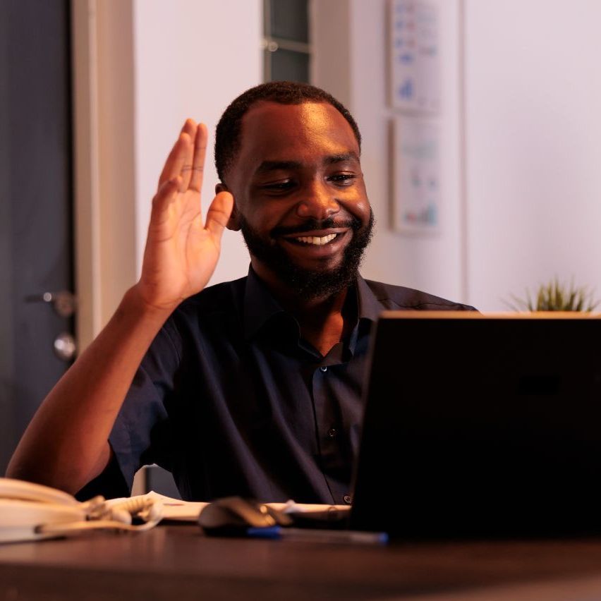 A woman is writing on a clipboard while a man wearing a mask looks on.