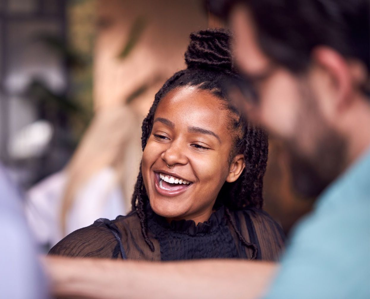 A woman is covering her face with her hands.