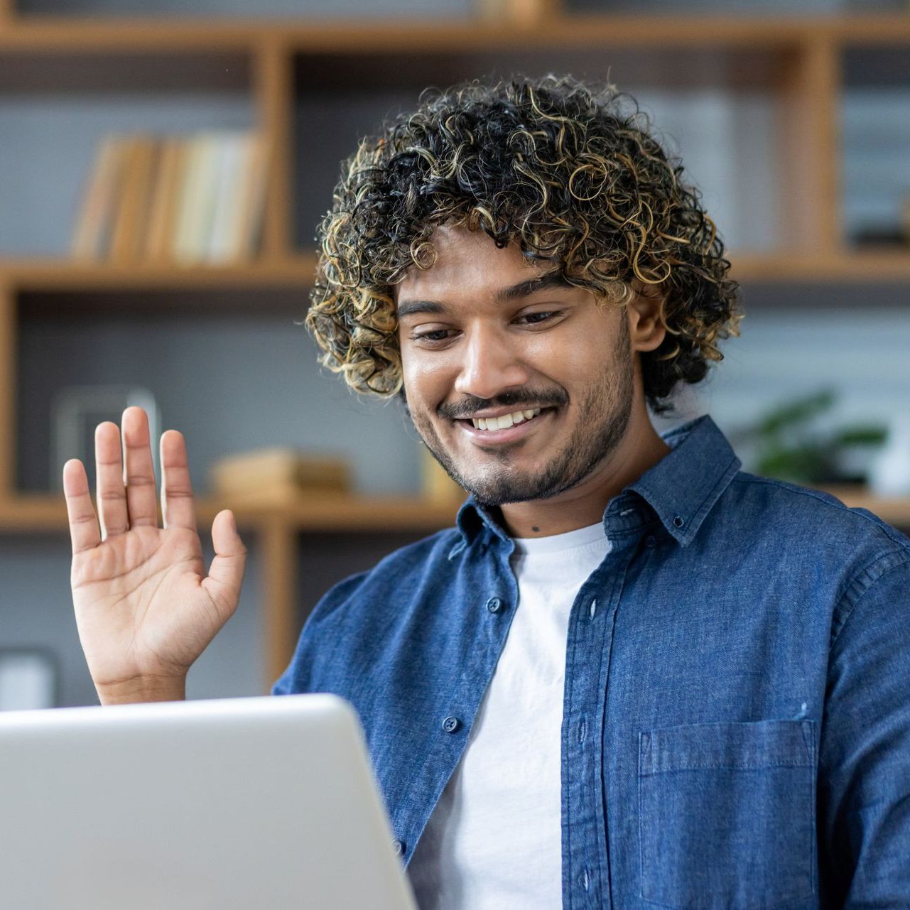 A woman is writing on a clipboard while a man wearing a mask looks on.