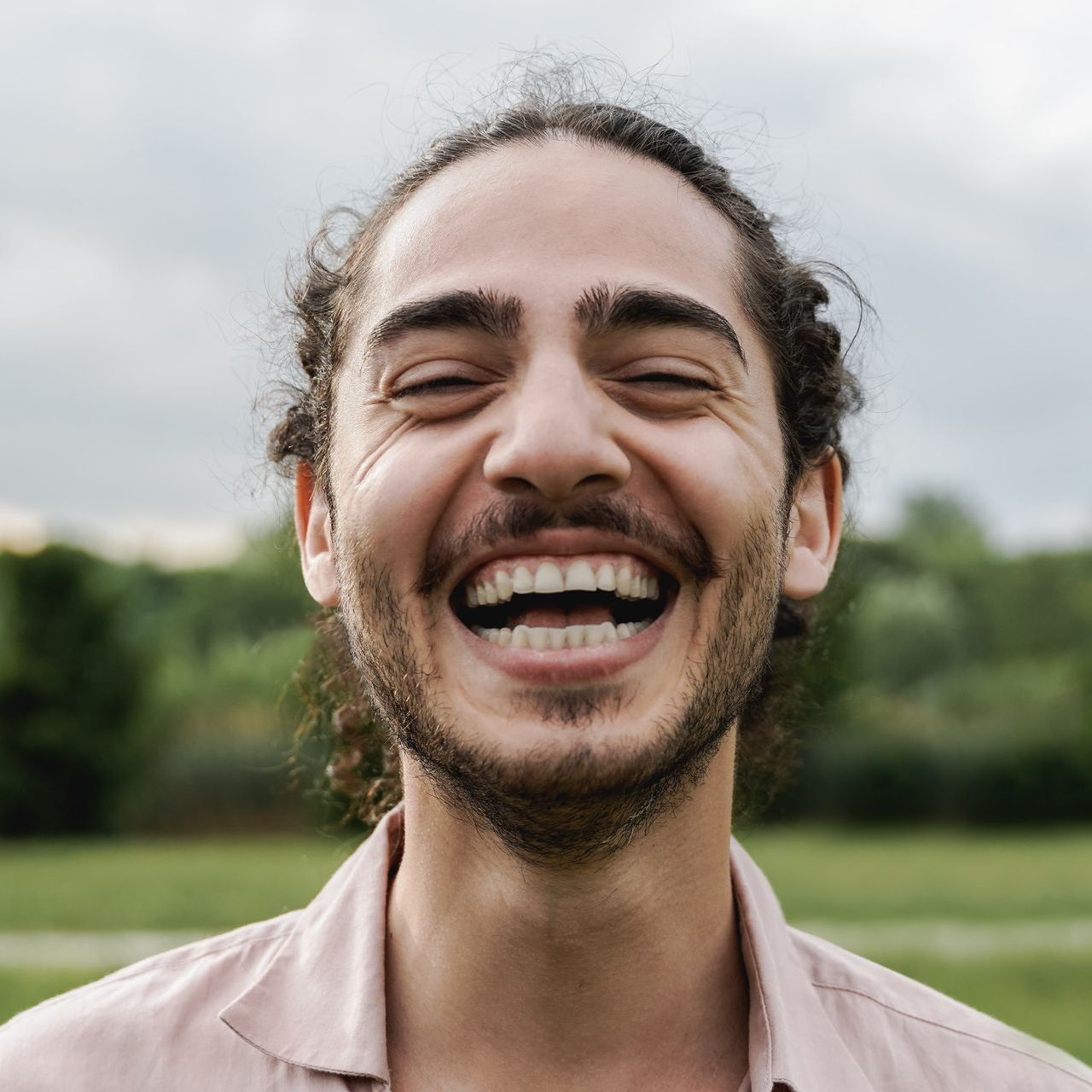 A woman is covering her face with her hands.