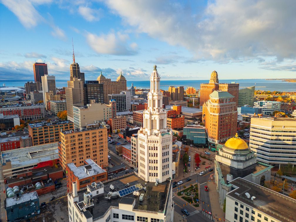 A woman with long dark hair is smiling for the camera.