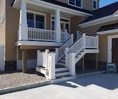 A house with a large porch and stairs leading up to it.