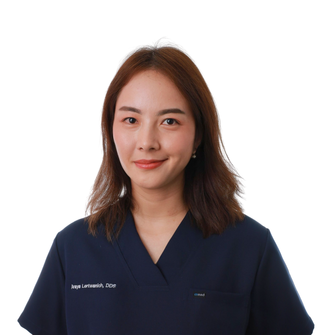 Woman in blue scrubs smiles at the camera; a professional portrait.