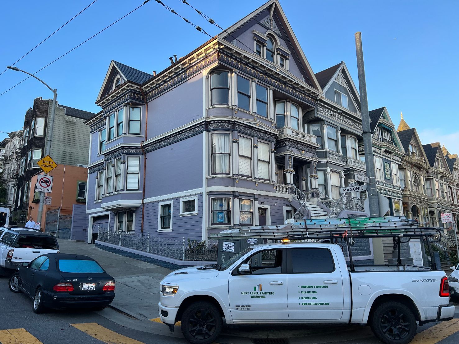 Victorian blue home in San Francisco with Next Level Painting truck is parked on corner of streets after finishing painting job