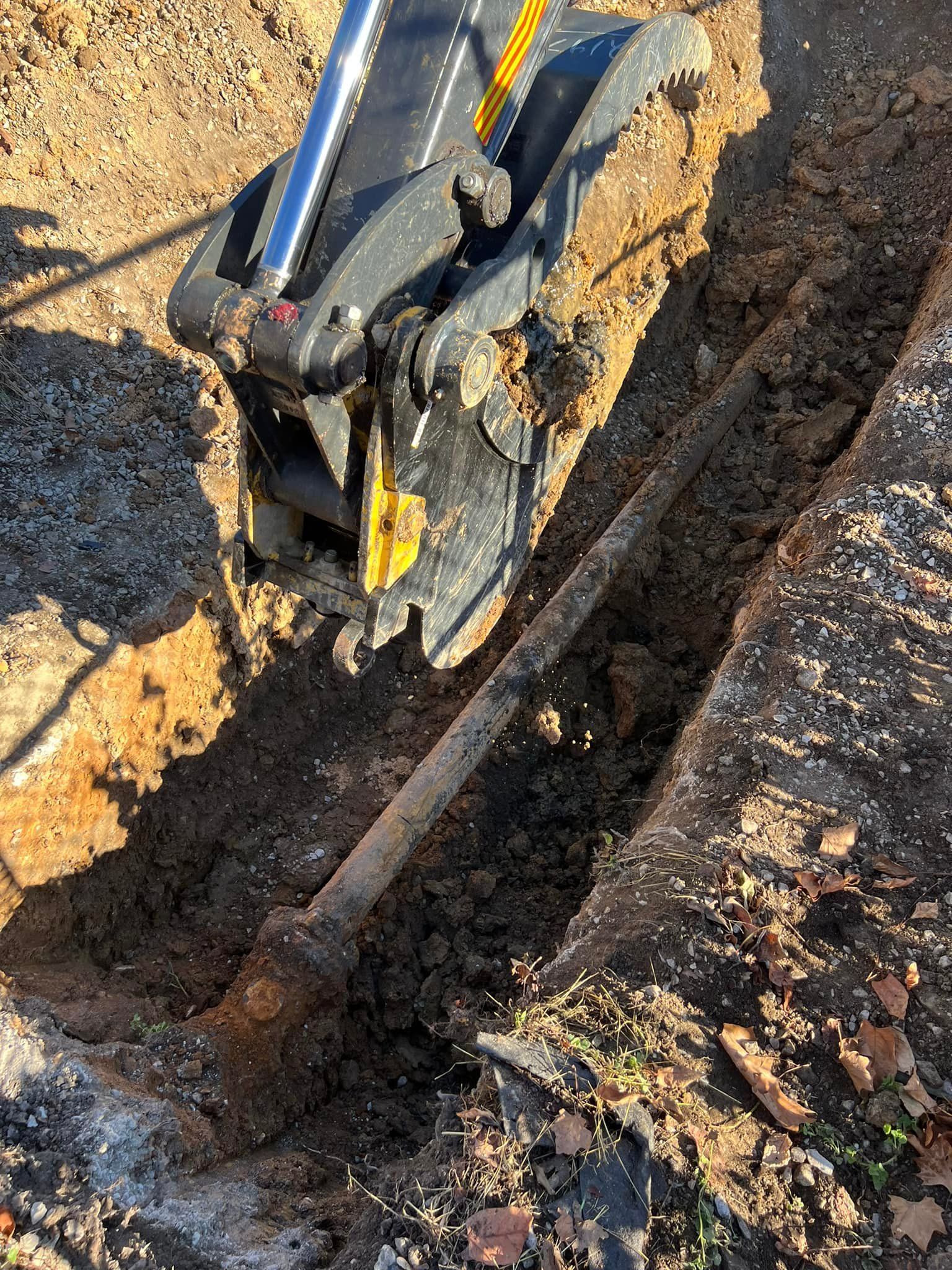 A person is using a shovel to dig a hole in the ground.