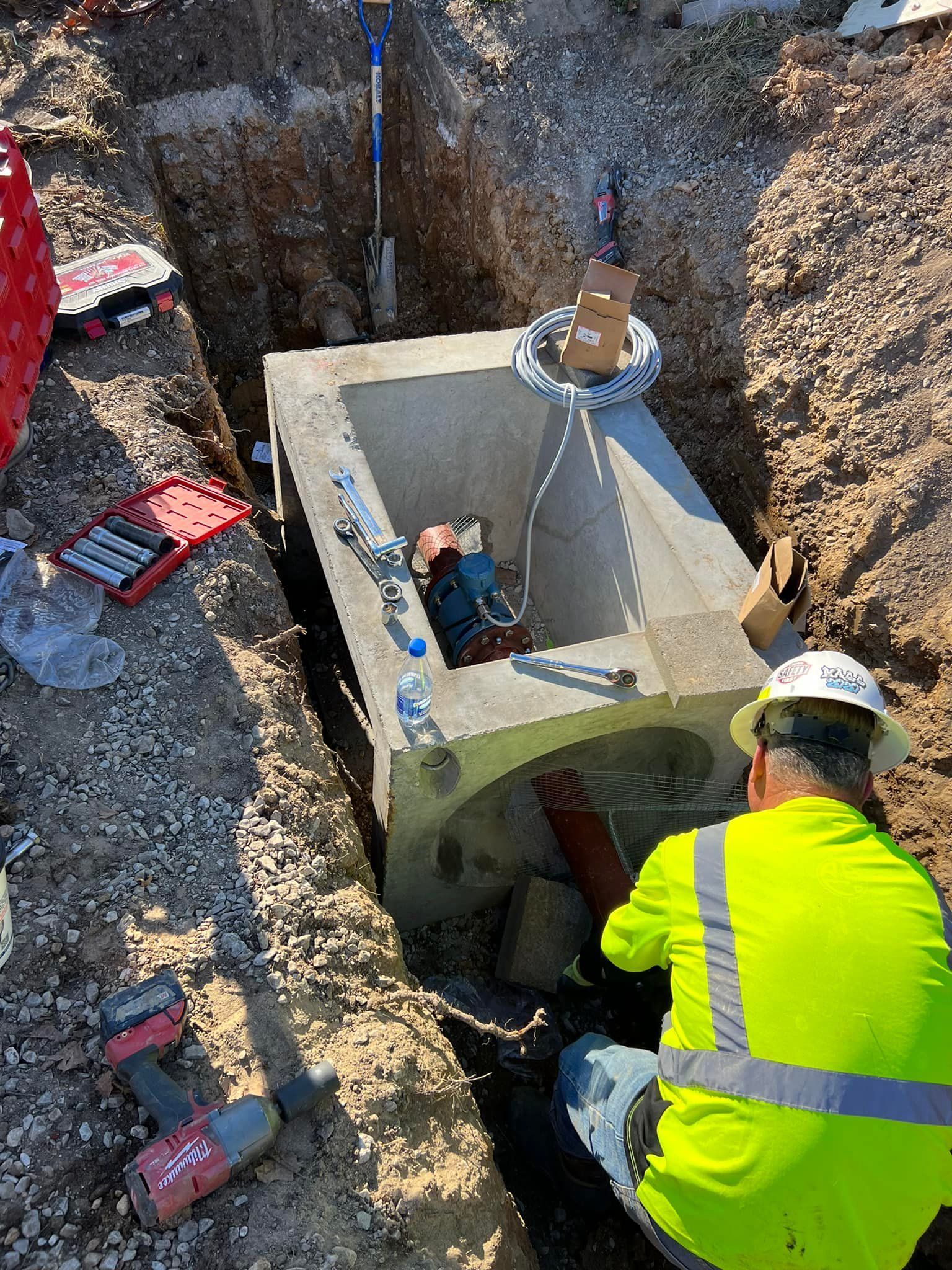 Three construction workers are posing for a picture on a sidewalk.