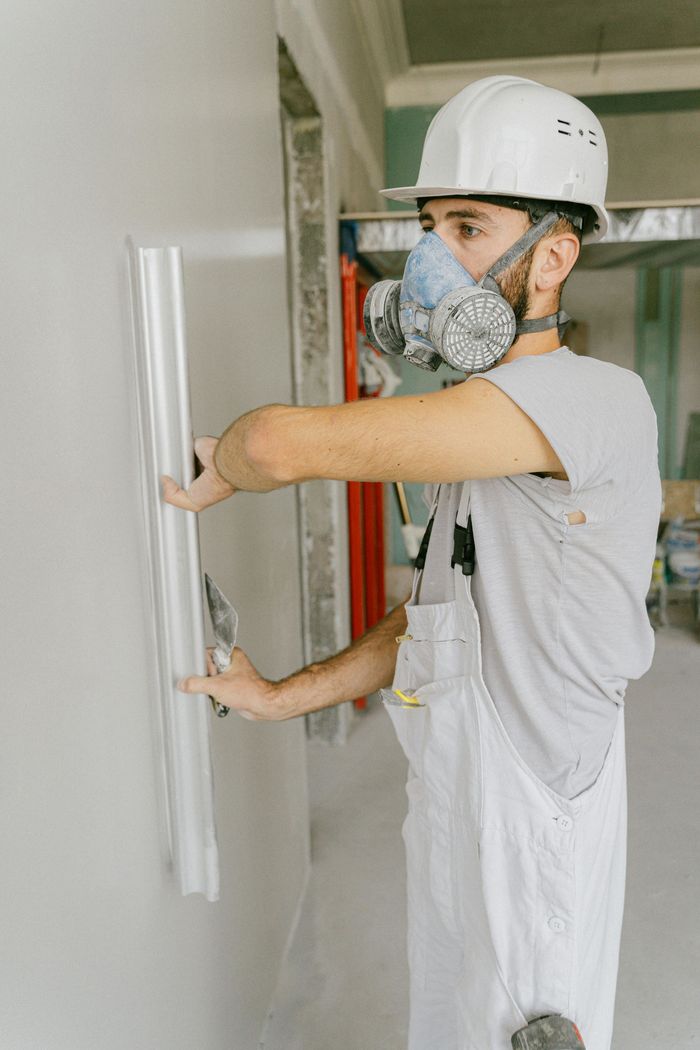 Man completing drywall repair