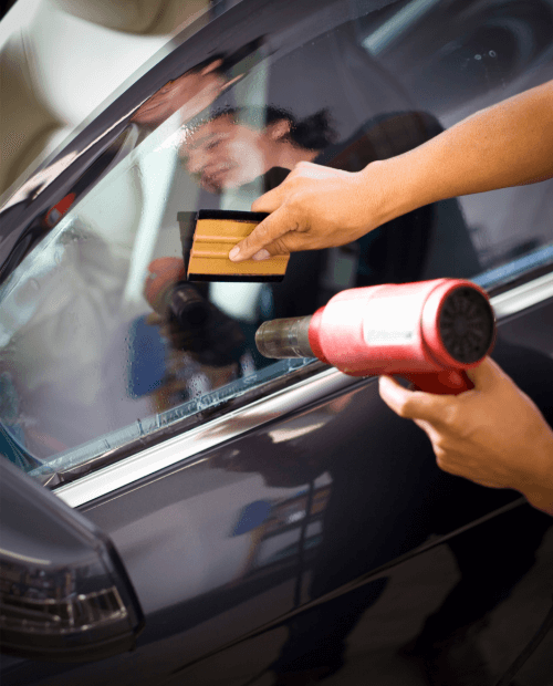 Heat Gun And Squeegee On Side Window